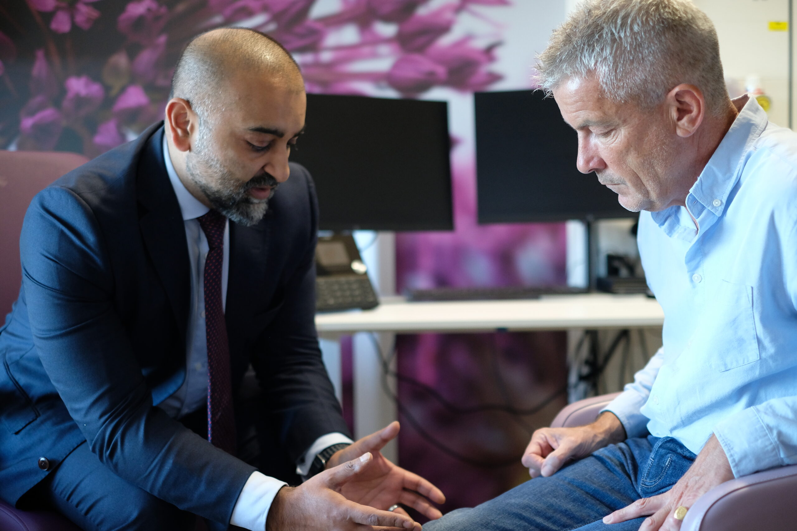 Consultant discussing an issue with his patient.